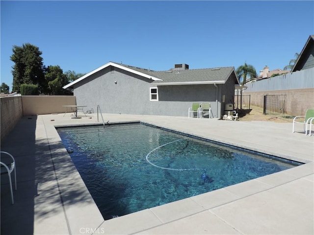 view of swimming pool featuring a fenced in pool, a patio area, and a fenced backyard