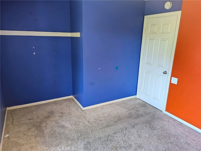 spare room with carpet floors and baseboards