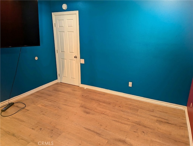 empty room featuring baseboards and wood finished floors