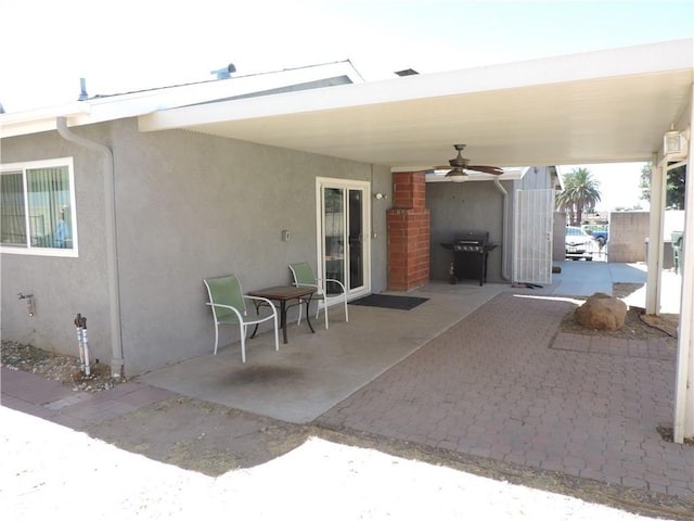 view of patio with ceiling fan and a grill