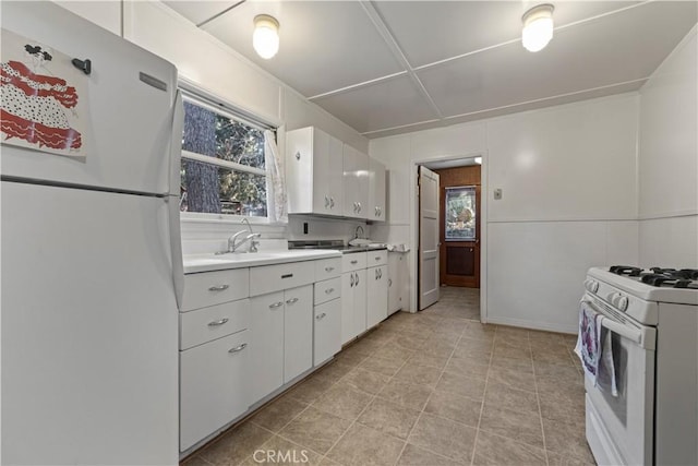 1779 Virginia St, Wrightwood, CA 92397 - kitchen featuring light countertops, white appliances, and white cabinets