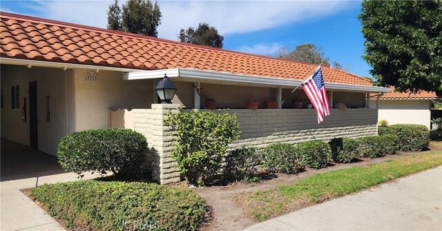 3311 Via Carrizo Unit P, Laguna Woods, CA 92637 - view of front of property with stucco siding and a tile roof