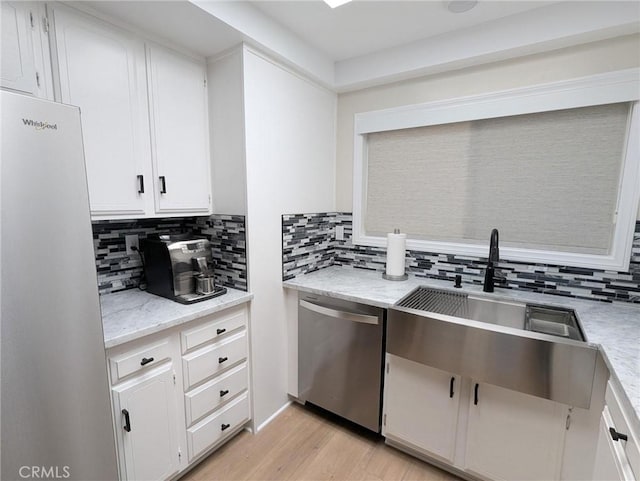 3311 Via Carrizo Unit P, Laguna Woods, CA 92637 - kitchen featuring stainless steel appliances, decorative backsplash, light wood finished floors, white cabinetry, and a sink
