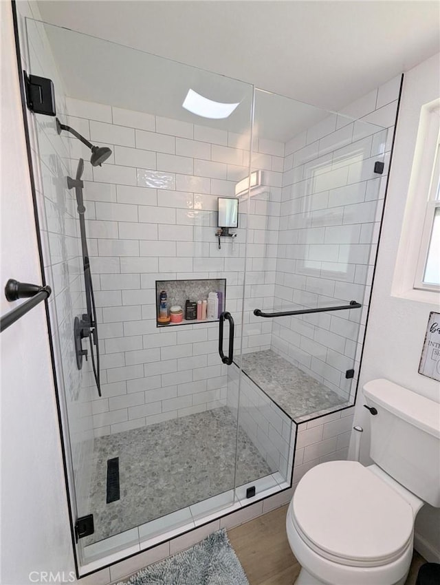 3311 Via Carrizo Unit P, Laguna Woods, CA 92637 - bathroom featuring toilet, a shower stall, and wood finished floors