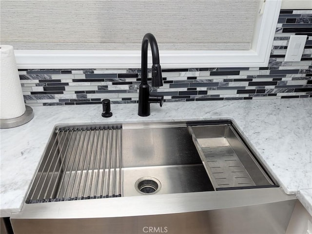 3311 Via Carrizo Unit P, Laguna Woods, CA 92637 - kitchen view of a sink, decorative backsplash, and light stone countertops