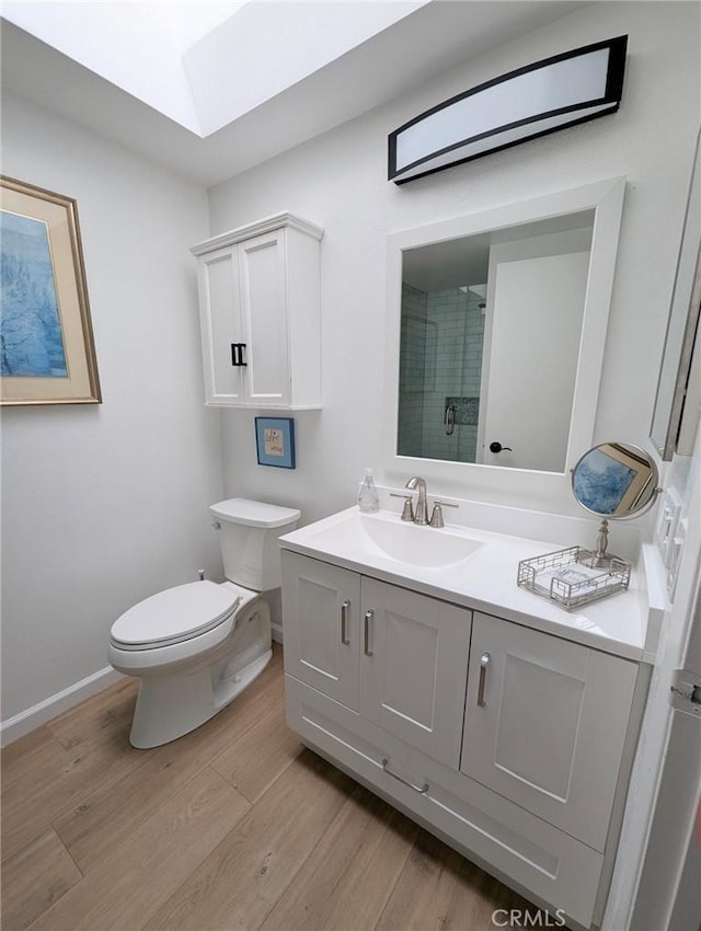 3311 Via Carrizo Unit P, Laguna Woods, CA 92637 - full bath with a skylight, wood finished floors, toilet, vanity, and a tile shower