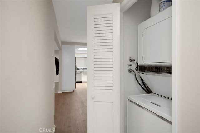 3311 Via Carrizo Unit P, Laguna Woods, CA 92637 - laundry area featuring stacked washing machine and dryer and wood finished floors