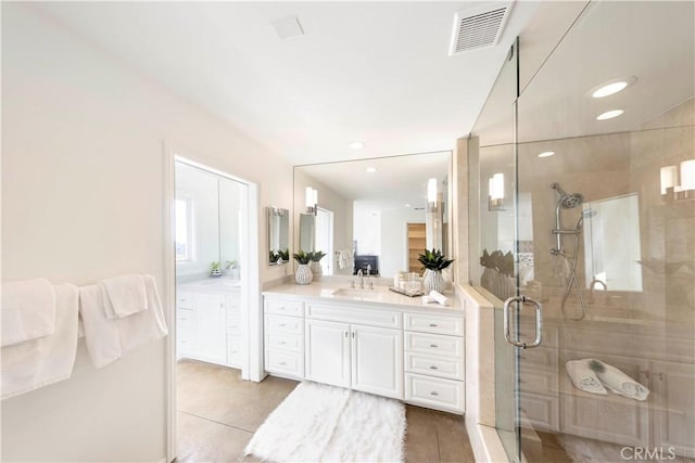 bathroom with recessed lighting, visible vents, a stall shower, vanity, and tile patterned flooring