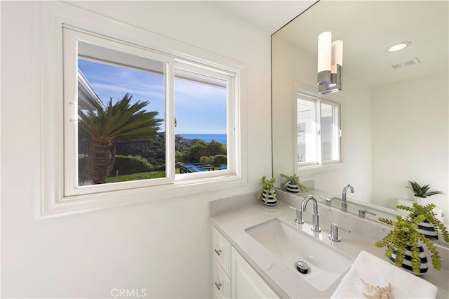 bathroom featuring recessed lighting, visible vents, and vanity