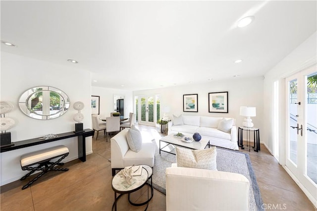 living room featuring a wealth of natural light, recessed lighting, french doors, and finished concrete flooring