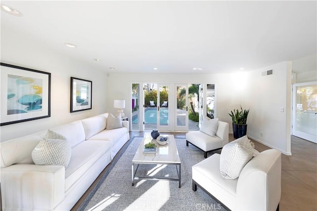 living room featuring baseboards, french doors, and recessed lighting