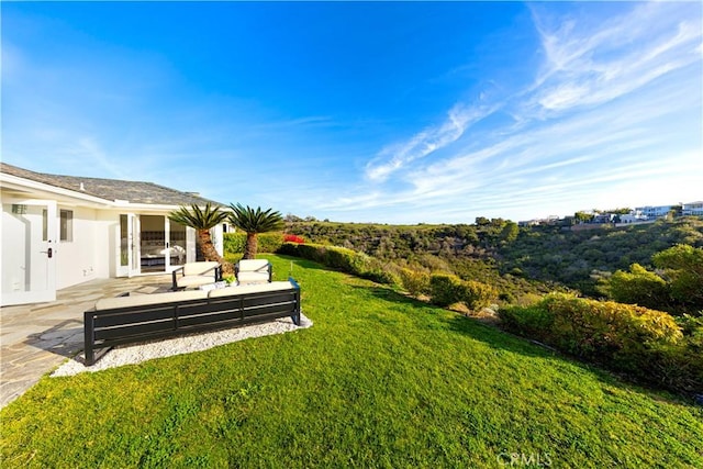 view of yard with outdoor lounge area and a patio area