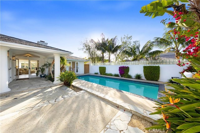 view of swimming pool with french doors, a patio area, a fenced backyard, and a fenced in pool