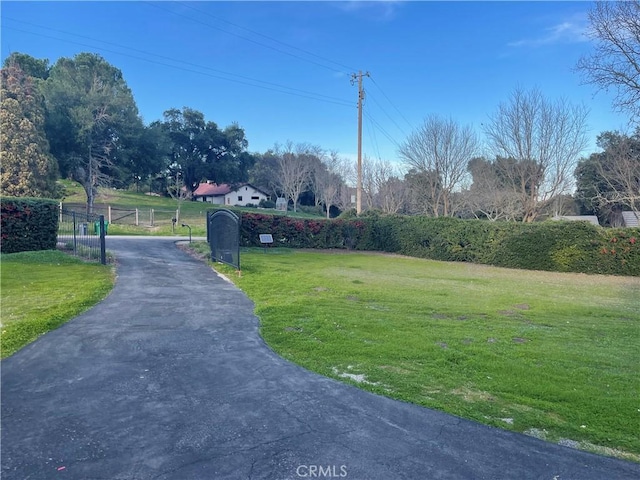 view of road featuring driveway, a gate, and a gated entry