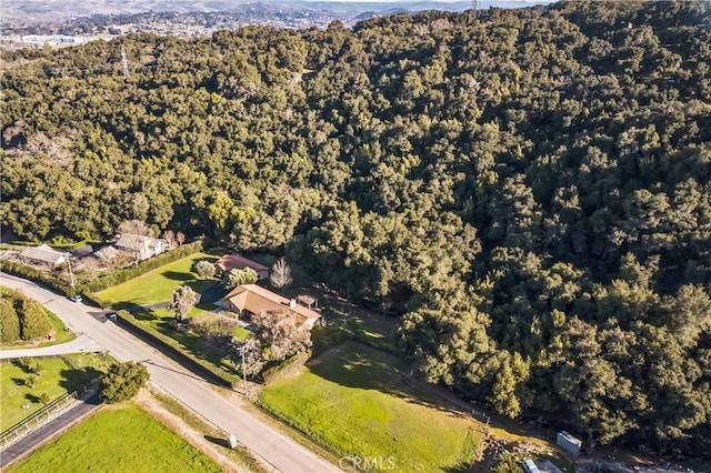 drone / aerial view featuring a forest view