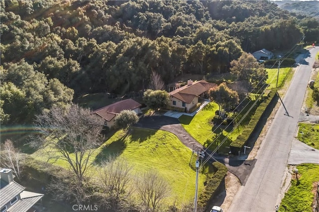 drone / aerial view with a wooded view