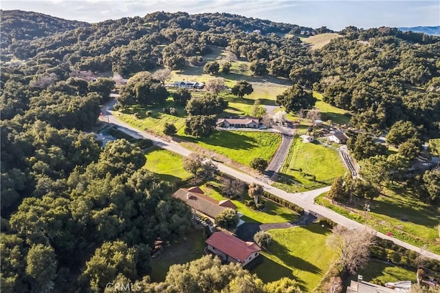 birds eye view of property with a forest view