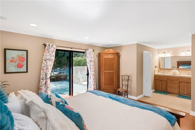 bedroom featuring baseboards, connected bathroom, access to exterior, a sink, and recessed lighting