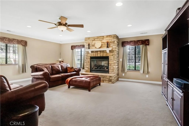 living area with carpet flooring, a healthy amount of sunlight, a fireplace, and baseboards