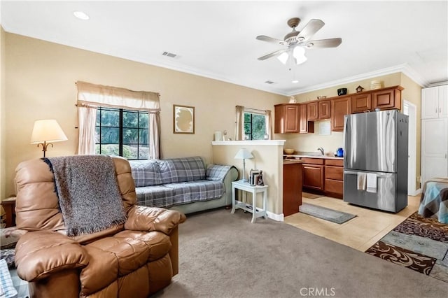 kitchen with freestanding refrigerator, open floor plan, and brown cabinets