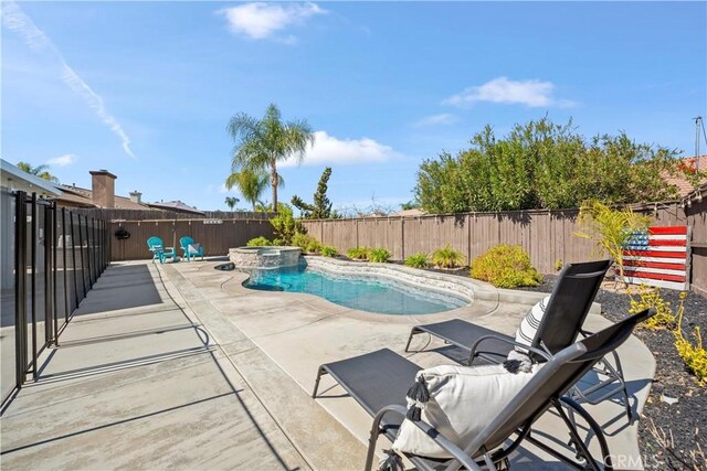 view of pool with a patio area, a fenced backyard, and a pool with connected hot tub