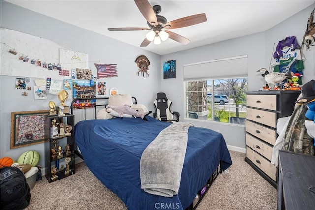 carpeted bedroom featuring ceiling fan and baseboards