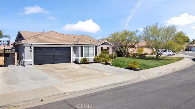 single story home featuring a tile roof, stucco siding, concrete driveway, a garage, and a front lawn