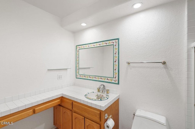 bathroom featuring recessed lighting, vanity, and toilet