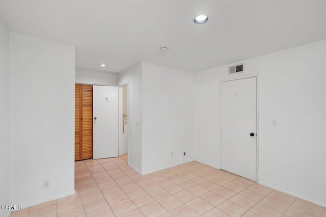 unfurnished room with recessed lighting, visible vents, and light tile patterned floors