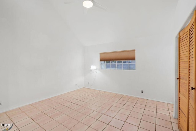 unfurnished room with vaulted ceiling and a ceiling fan