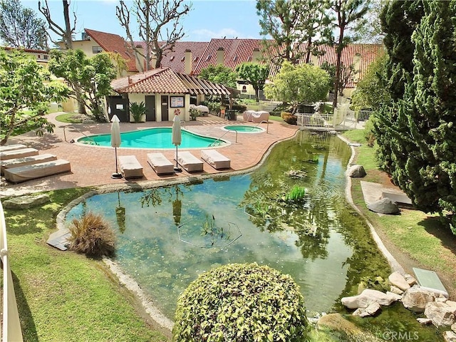 pool featuring fence and a patio