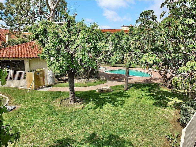 view of yard with an outdoor pool and fence