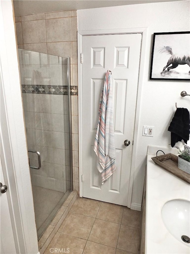 full bath with tile patterned flooring, vanity, and a shower stall