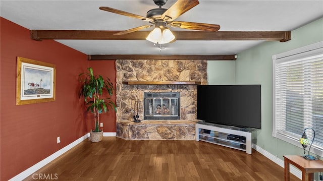 unfurnished living room with a stone fireplace, wood finished floors, and a healthy amount of sunlight