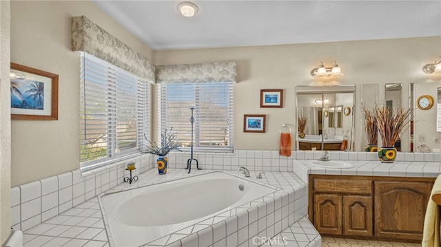 bathroom with a garden tub and vanity