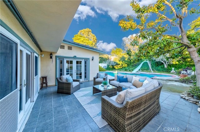 view of patio featuring french doors, an outdoor pool, and an outdoor living space