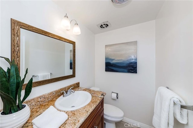 bathroom with visible vents, vanity, toilet, and baseboards