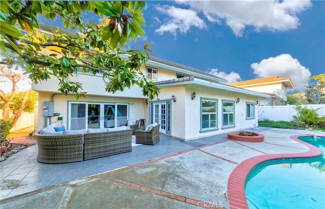 back of house with french doors, a patio area, a fenced backyard, and an outdoor hangout area