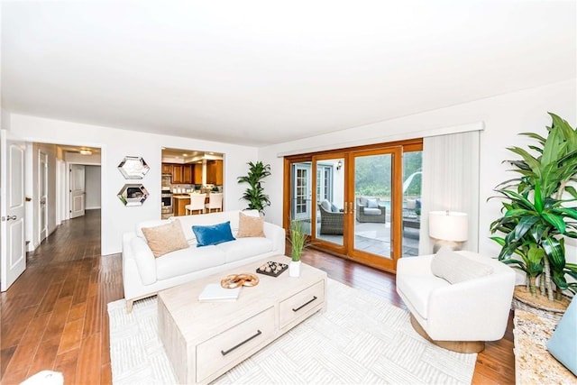 living area featuring light wood-type flooring and french doors