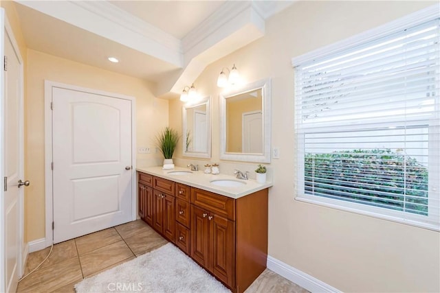 full bathroom with double vanity, tile patterned flooring, crown molding, and a sink