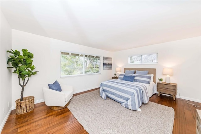 bedroom featuring dark wood-style floors and baseboards