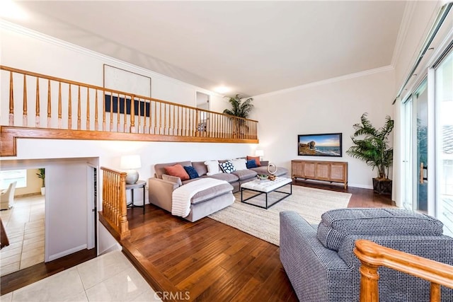 living area with wood finished floors and crown molding