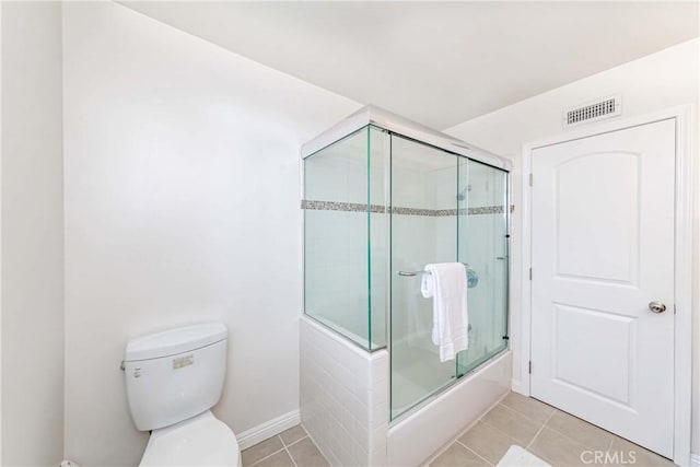 bathroom with tile patterned flooring, enclosed tub / shower combo, visible vents, and toilet