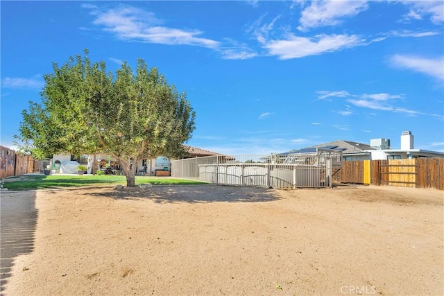 view of yard with fence and a gate