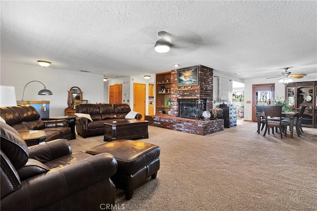 carpeted living room featuring a brick fireplace, ceiling fan, and a textured ceiling