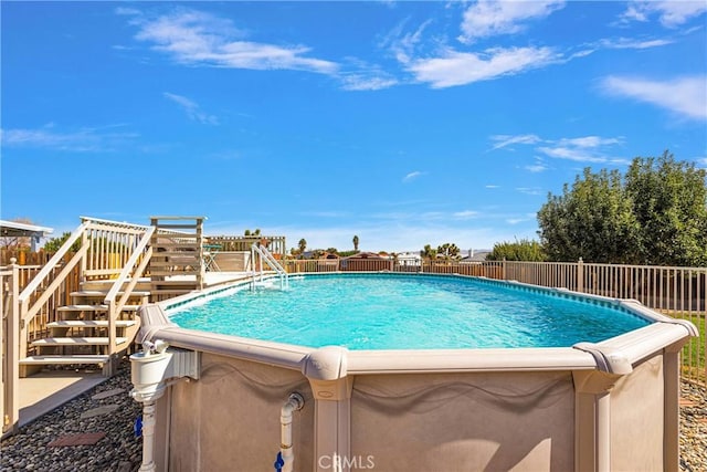 view of swimming pool with a fenced in pool and stairs