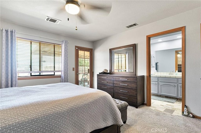 bedroom with light carpet, multiple windows, visible vents, and access to exterior