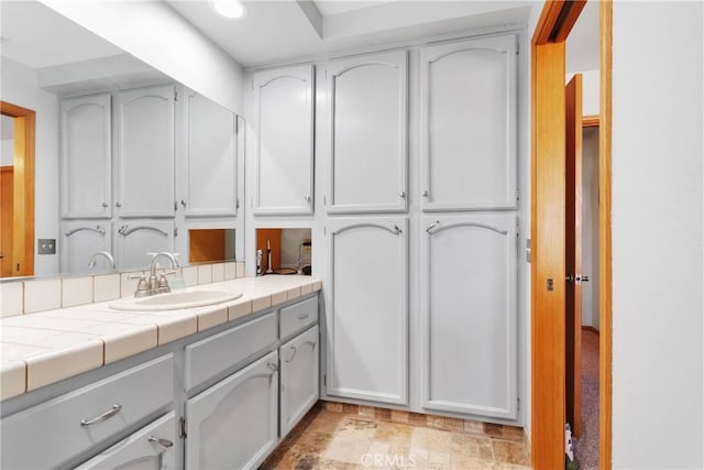 bathroom with a closet and vanity