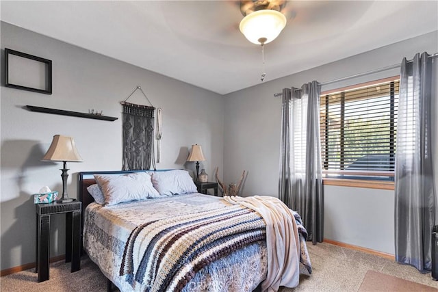 bedroom featuring light carpet, ceiling fan, and baseboards