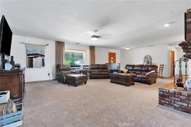 living room with carpet, baseboards, and a textured ceiling